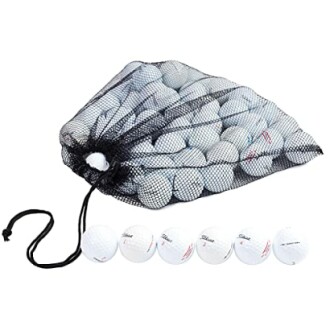 Mesh bag filled with golf balls and six golf balls outside.